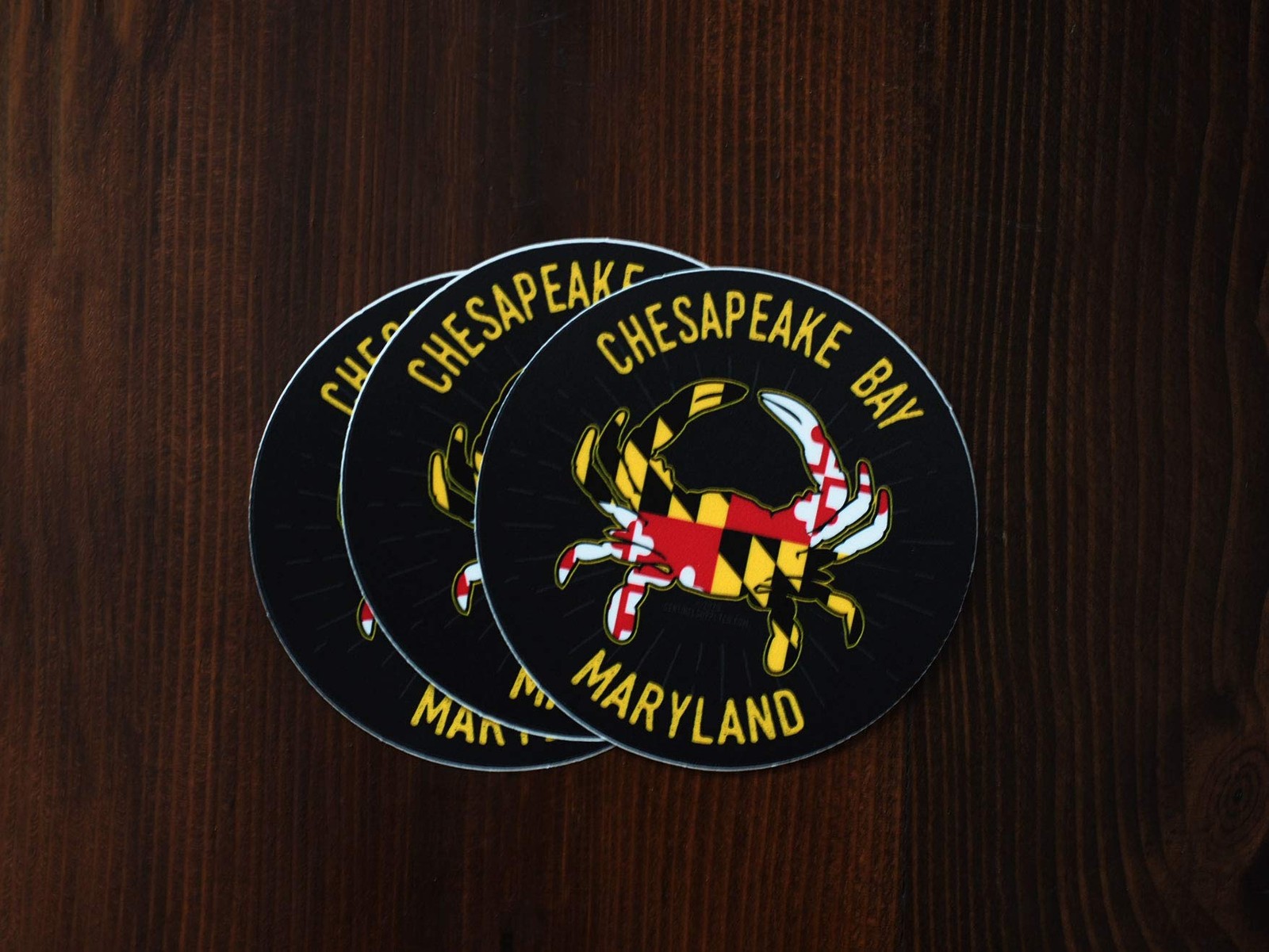 Dark Grey Background With Yellow, Red, White, and Black Crab. Yellow Lettering.